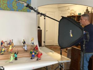 Photographer Otto Piron is in Cynthia Weill's apartment, taking photos of the Oaxacan bird carvings by Avelino Pérez.